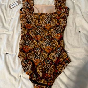 One piece off the shoulder from Albion fit-never worn! Perfect condition.